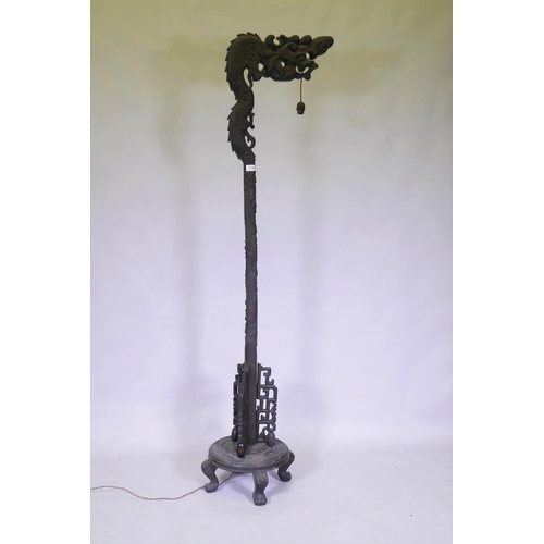 1110 - A Chinese carved hardwood dragon floor lamp, early C20th, 183cm high