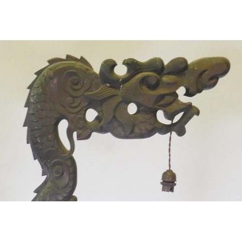 1110 - A Chinese carved hardwood dragon floor lamp, early C20th, 183cm high