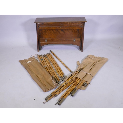 1111 - An officer's military campaign bed with concertina action, 25 x 809 x 52cm, and two sets of bamboo a... 