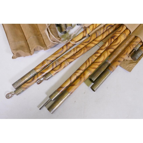 1111 - An officer's military campaign bed with concertina action, 25 x 809 x 52cm, and two sets of bamboo a... 