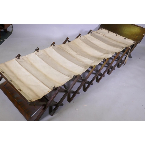 1111 - An officer's military campaign bed with concertina action, 25 x 809 x 52cm, and two sets of bamboo a... 