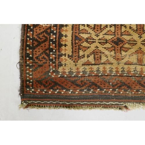 1121 - A gold ground Bokhara rug, and an Iranian rust and cream ground wool rug with an allover geometric d... 