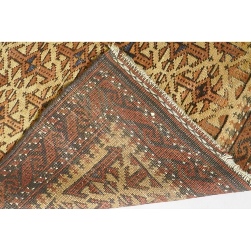 1121 - A gold ground Bokhara rug, and an Iranian rust and cream ground wool rug with an allover geometric d... 