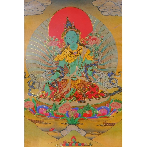 123 - A Tibetan printed Thangka with gilt details, on a silk scroll mount, 49 x 62cm