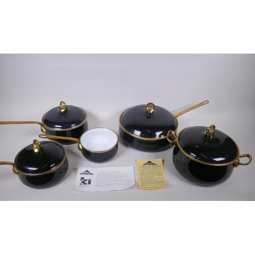 133 - A set of Kitchen Kapers International Ltd 'Hild' enamelled cookware with brass handles, in the Ebony... 