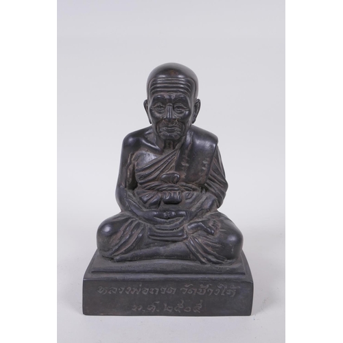 136 - A Tibetan filled bronze Buddha, inscription to front, 19cm high