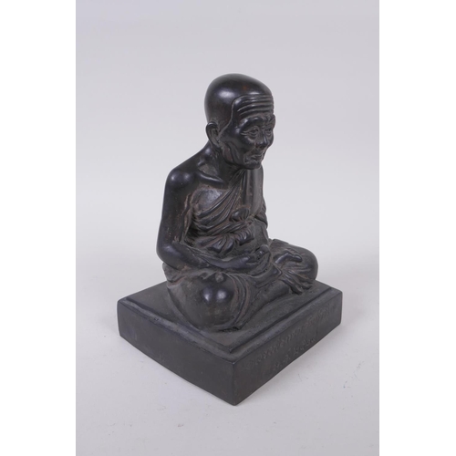 136 - A Tibetan filled bronze Buddha, inscription to front, 19cm high