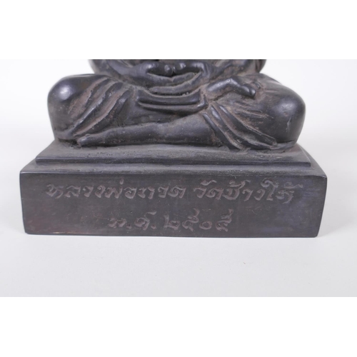 136 - A Tibetan filled bronze Buddha, inscription to front, 19cm high