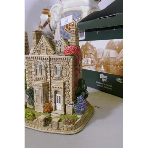 25 - A Lilliput Lane dolls' house, a 'Welcome Father Christmas' porcelain ornament by Janet King, a plant... 