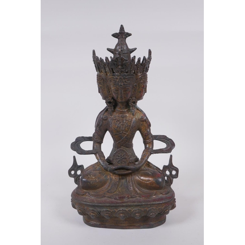 45 - A Tibetan bronze multi headed Buddha with remnants of gilt patina, 31cm high