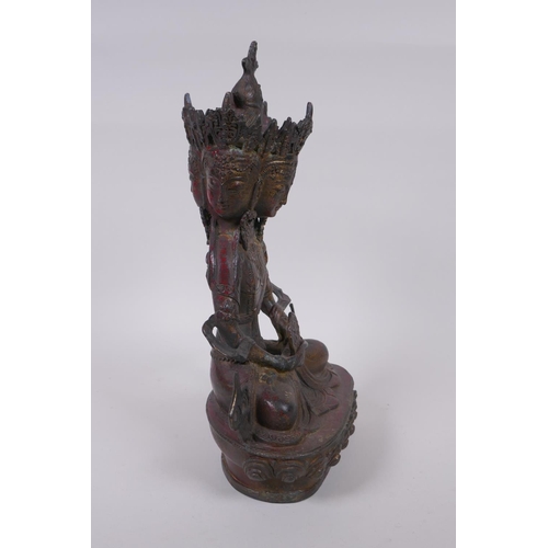 45 - A Tibetan bronze multi headed Buddha with remnants of gilt patina, 31cm high