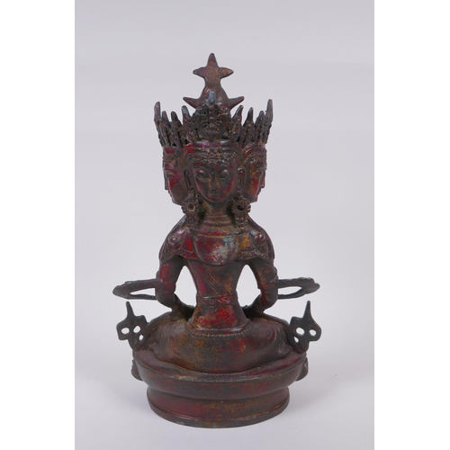 45 - A Tibetan bronze multi headed Buddha with remnants of gilt patina, 31cm high