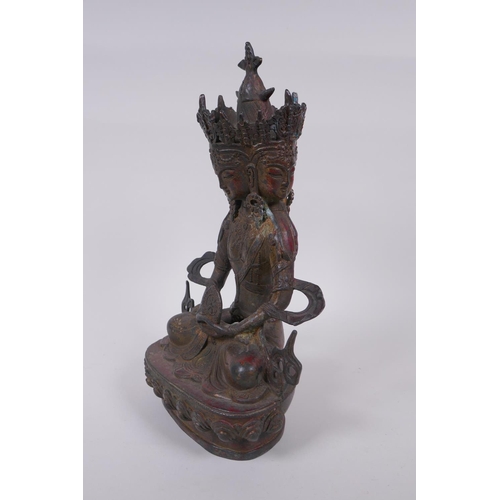 45 - A Tibetan bronze multi headed Buddha with remnants of gilt patina, 31cm high