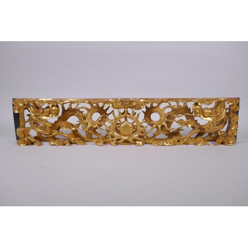 47 - A Chinese carved and giltwood panel decorated with two dragons and a pearl, 60 x 12cm, 5cm high