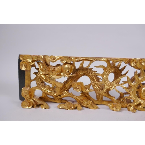 47 - A Chinese carved and giltwood panel decorated with two dragons and a pearl, 60 x 12cm, 5cm high