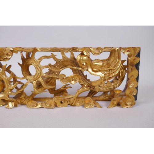 47 - A Chinese carved and giltwood panel decorated with two dragons and a pearl, 60 x 12cm, 5cm high