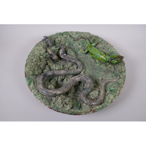 49 - A late C19th Portuguese Palissy majolica charger by Manuel Mafra for Caldas, decorated with a snake ... 