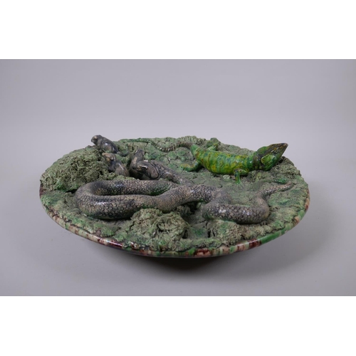 49 - A late C19th Portuguese Palissy majolica charger by Manuel Mafra for Caldas, decorated with a snake ... 