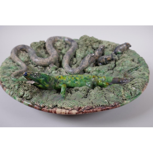 49 - A late C19th Portuguese Palissy majolica charger by Manuel Mafra for Caldas, decorated with a snake ... 