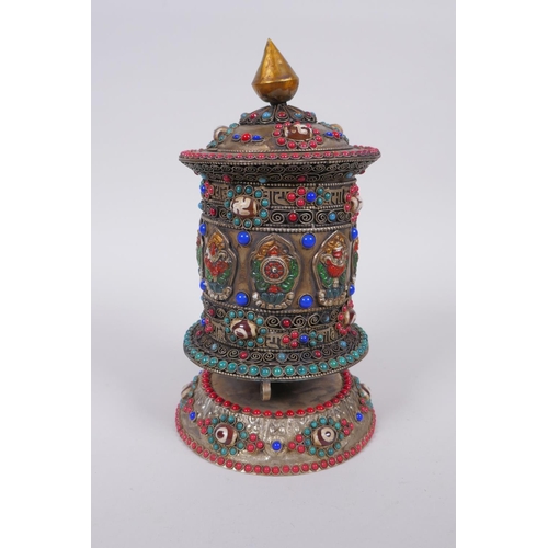 55 - A Tibetan white metal prayer wheel with painted details, set with agate eye beads, turquoise etc, 21... 