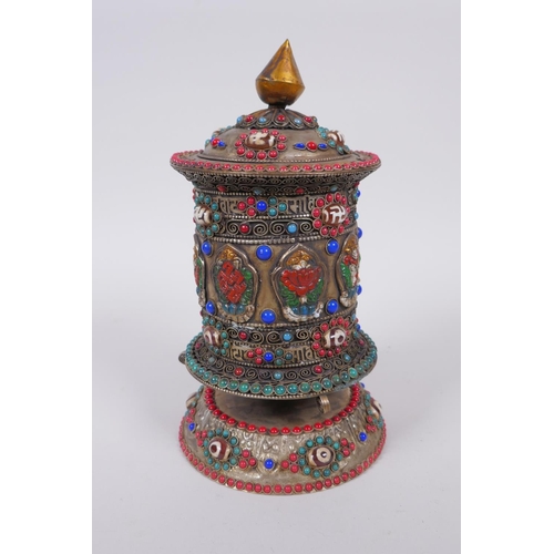 55 - A Tibetan white metal prayer wheel with painted details, set with agate eye beads, turquoise etc, 21... 