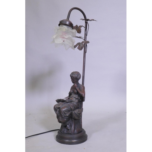 61 - A bronzed composition table lamp in the form of a seated young woman reading a book, 57cm high