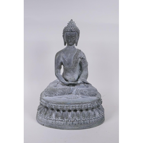 62 - A Tibetan cast bronze Buddha with a vert de gris patina, 35cm high