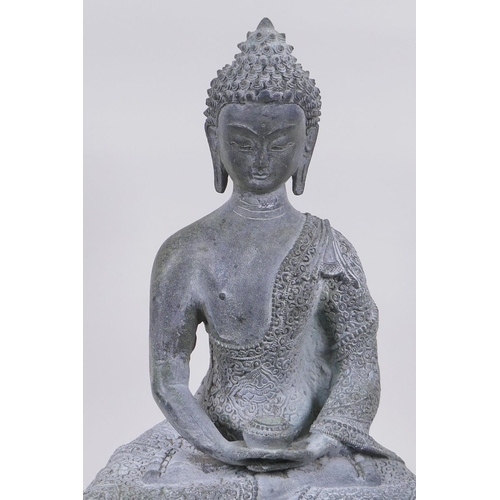 62 - A Tibetan cast bronze Buddha with a vert de gris patina, 35cm high