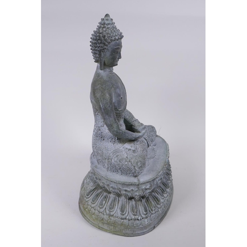 62 - A Tibetan cast bronze Buddha with a vert de gris patina, 35cm high