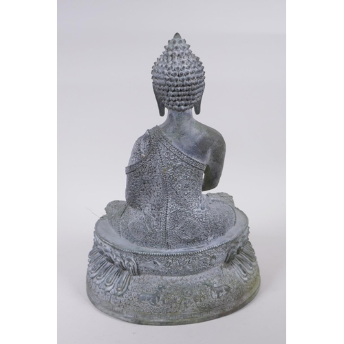 62 - A Tibetan cast bronze Buddha with a vert de gris patina, 35cm high