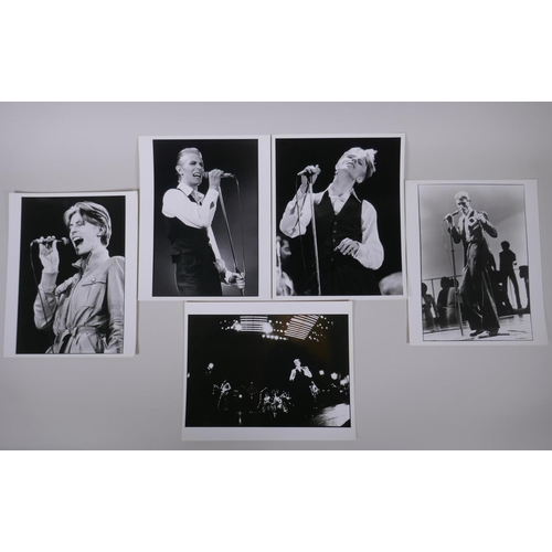 75 - A collection of five black and white press photographs of David Bowie circa 1976, including one by M... 