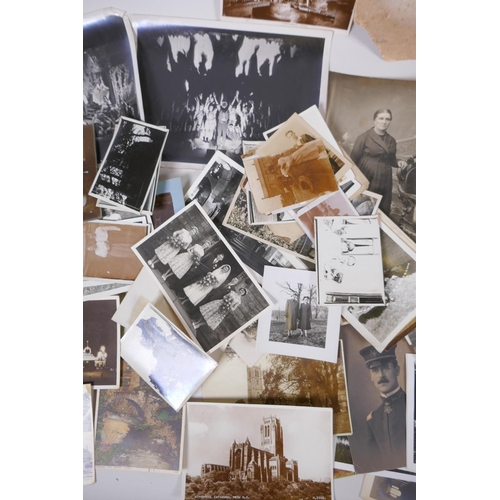 85 - A large quantity of late C19th and early C20th black and white photographs and postcards, of social ... 