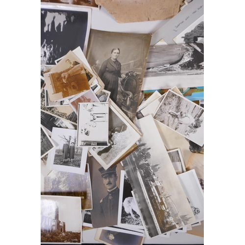 85 - A large quantity of late C19th and early C20th black and white photographs and postcards, of social ... 