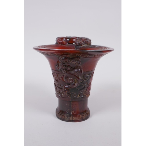 93 - A Chinese horn libation cup with climbing kylin decoration, character mark to base, 12cm high