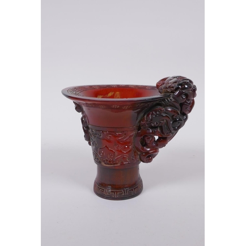 93 - A Chinese horn libation cup with climbing kylin decoration, character mark to base, 12cm high