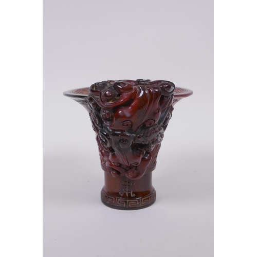 93 - A Chinese horn libation cup with climbing kylin decoration, character mark to base, 12cm high