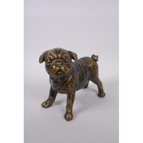 99 - A gilt bronze pug dog, 21cm long