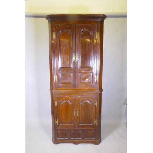 1075 - A Georgian painted pine standing corner cupboard in two sections, arched and fielded door panels, br... 