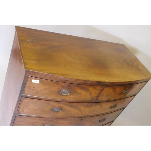 1067 - A Georgian mahogany bowfront chest of two over three drawers with cock beaded detail and brass plate... 