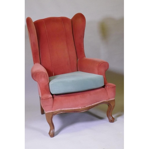 1094 - A pair of Georgian style wing back armchairs, with shaped backs