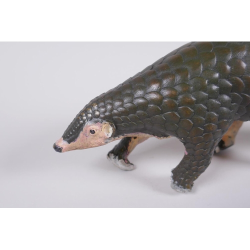 103 - A cold painted filled bronze figure of a pangolin with a pup riding on its back, 32cm long