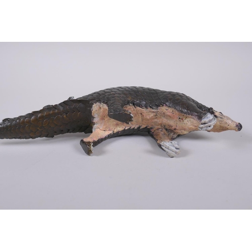 103 - A cold painted filled bronze figure of a pangolin with a pup riding on its back, 32cm long