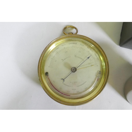 106 - An antique brass cased aneroid barometer, the silvered dial inscribed E.J. Dent, Paris, 12cm diamete... 