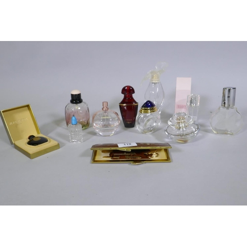 110 - Ten scent bottles, Gucci, Yves St Laurent, Guerlain, Ricci, and a leather cased vanity set