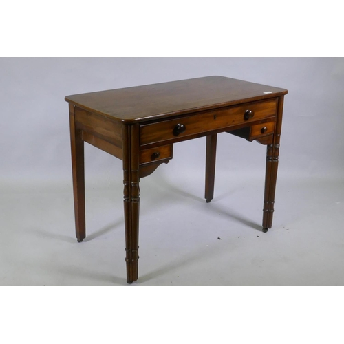 1115 - A C19th mahogany writing table, the central drawer with fitted compartments flanked by two smaller, ... 