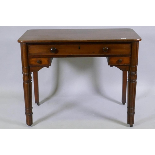 1115 - A C19th mahogany writing table, the central drawer with fitted compartments flanked by two smaller, ... 