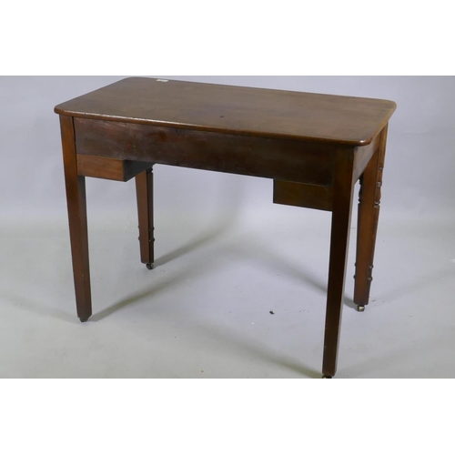 1115 - A C19th mahogany writing table, the central drawer with fitted compartments flanked by two smaller, ... 