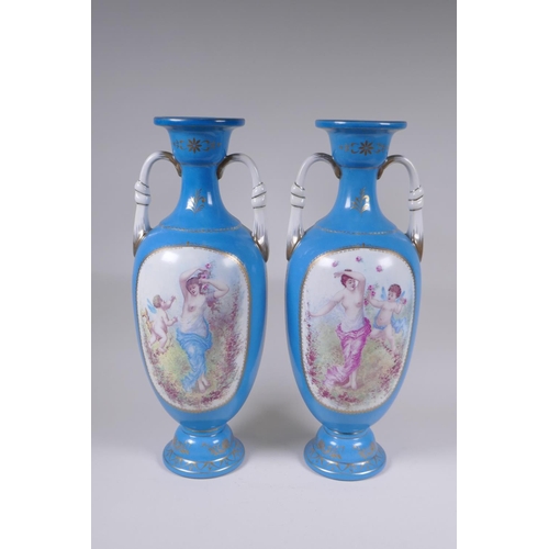 117 - A pair of Sevres style porcelain two handled urns, with decorative panels depicting maidens and wing... 