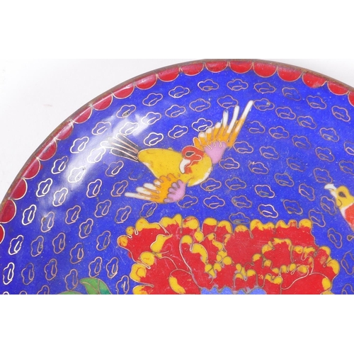 118 - A Chinese blue ground cloisonne dish decorated with birds and flowers, 18cmn diameter