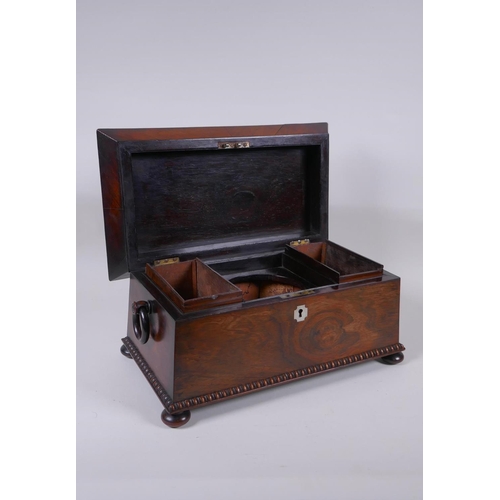 12 - An antique rosewood sarcophagus shaped tea caddy with mother of pearl inlay, two handles and bun fee... 